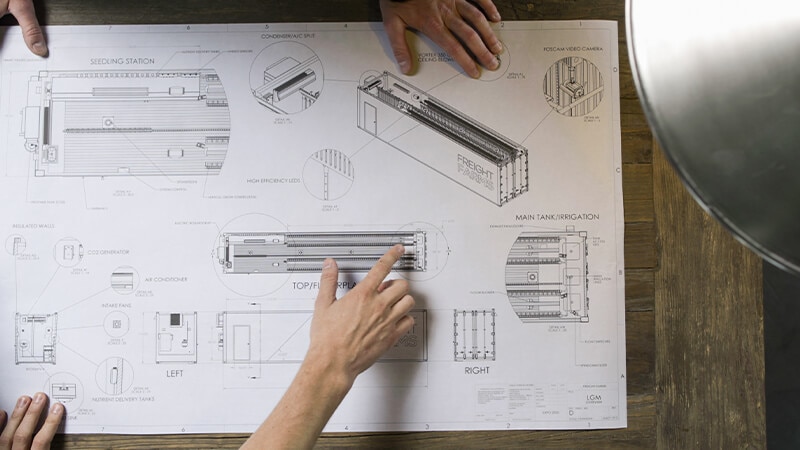Scientists reviewing blue print for a project